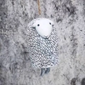 Detail of handmade resin sheep wind chime with black swirl patterns and natural jute rope - Sheep
