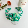 Detail of wide knotted headband with green and pink floral pattern on satin fabric - Green Printed Wide Knotted Headband