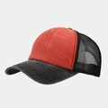 Detail of vintage washed trucker hat featuring breathable mesh and distressed red visor - Orange