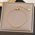 Gold stainless steel bracelet featuring hollow paw print charms on a brown jewelry box - Gold Hollow Paw Print Fine Chain (5109)