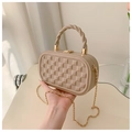 Close-up of beige quilted crossbody bag with twisted top handle and gold chain strap - Khaki