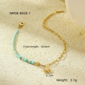 Detalle de pulsera dorada con cuentas turquesas y colgante de sol sobre fondo de arena - Dorado/Azul Celeste (NMSB-B828-1)