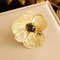Elegant gold flower jewelry set with hollow petals and black pearl center on display - Single Ring-Black Bead (R484)