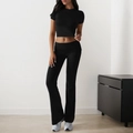 Women's black two-piece yoga set featuring short sleeve crop top and flared leggings - S / Black