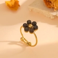 Detailed shot of golden flower ring featuring cat eye stones and adjustable open band design - Gold Black Cat's Eye Ring