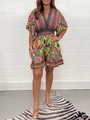 Detail of V-neck bohemian floral print jumpsuit with ruffled hem and elastic waist - S / Top And Bottom / Green