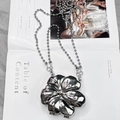Silver flower-shaped metal clutch bag with bead chain on fashion magazine backdrop - 9.5*11*4cm / Silver