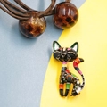 Unique black Egyptian cat brooch with colorful enamel floral patterns on bright background - Black Multi-color Cat