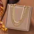 Three layered gold necklaces with snake and figaro chains on a square jewelry box - Figaro Triple Chain / Gold
