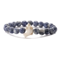 Detail of blue spotted stone beaded bracelet with beige dolphin shaped charm centerpiece - Sodalite