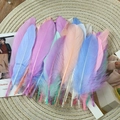 Colorful DIY goose feathers for dreamcatchers on a round straw mat background - Stiff Macaron Mixed Colors (50Pcs)