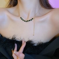 Gold plated necklace with green gemstones and adjustable chain shown on a model - 20# Necklace-Green