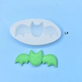 Detail of bat-shaped silicone mold with a green finished cartoon bat craft on blue background - Cartoon Bat Style (L#)