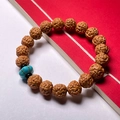 Natural Nepal Rudraksha Bodhi seed bracelet with blue turquoise bead on red background - Toad Back 8-10mm (Turquoise Pumpkin)