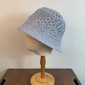Close-up of light blue hollow crochet pattern on breathable knit bucket hat for women - M / Light Blue