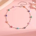 Close-up of a colorful evil eye enamel beaded necklace with silver chain detailing - Gold Necklace