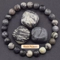 Macro shot of Black Picasso Jasper beaded bracelet with natural raw stones in grey tones - Grey Map Stone