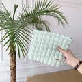 Detail of light green bubble canvas cosmetic bag with textured puff fabric and logo label - Bubble Light Green
