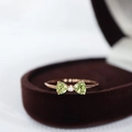 Rose gold bow ring with heart-cut green stones and small diamond in a velvet box - Rose Gold Green Heart Bow Ring
