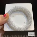 Elegant beaded crystal elastic hair tie in white color on a display card holder - White