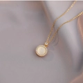 Rotating cat-eye stone necklace in gold titanium steel with zircon halo on silk background - Cat Eye Necklace / Gold