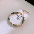 Close-up of vintage gold metal bracelet with green bamboo beads and white pearls - Green Bamboo Bracelet(4#)