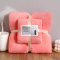 Pink coral fleece towel set with decorative ribbon packaging on a wooden surface - Towel + Bath Towel [Mesh Bag] / Pink Coral Fleece
