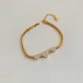 Gold-plated stainless steel snake chain bracelet featuring three micro-pave heart charms - Gold Triple Heart Snake Chain (SBK542)