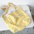 Detailed top view of large yellow floral canvas tote bag with book and tulip decor - 4D Yellow Daisy