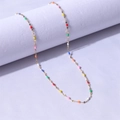 Detail of 18k gold plated chain with colorful enamel beads on a white pedestal - Gold + Multi-color / 40+5cm