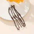 Set di 5 braccialetti intrecciati marroni regolabili con anelli in metallo argento - 5 Pezzi / Marrone