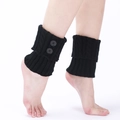 Chic black knitted leg warmers for women featuring a stylish cable knit and double buttons - One Size / Black