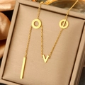 Close-up of gold LOVE pendant necklace with pearls on champagne satin in jewelry box - LOVE Letter Rings