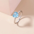 Detailed view of a silver ring featuring a heart-shaped blue gemstone on soft geometric blocks - Adjustable Open / Blue Heart Gemstone/Silver Band