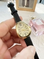 Detail of gold snake-shaped watch dial with black leather strap and Roman numerals - Black Gold Dial (45164)