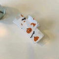 Detail view of square Halloween claw clip with pumpkin and bat prints on cream base - Pumpkin-White Claw Clip