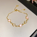 Detail of adjustable gold flower bracelet with pink enamel and white zircon petals - Five-Petal Flower / Gold-Pink