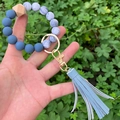 Close-up of a beaded keychain bracelet with blue marble beads and a faux leather tassel - Light Blue PU Tassel Marble Beaded (款6)