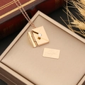 Rose gold envelope necklace with hidden 'I love you' message on a jewelry box - LOVE Lettering / Rose Gold