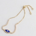 Detail of gold Evil Eye bracelet with blue enamel, zircon stones and adjustable slider clasp - Blue
