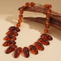 Macro shot of amber acrylic beads and gold metal spacers on textured wood - Style 2 - Coffee Brown (WN1679)