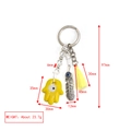 Detailed view of evil eye keychain with hamsa hand, feather charm and yellow silk tassel - Yellow Hamsa Feather