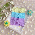 Three twisted nylon baby headbands with large bows in yellow, blue and purple pastel colors - Three-Piece Set / Beige, Blue, Purple