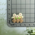 Close-up of resin flower fence charm on a centimeter scale ruler for size measurement - Beige Flower Fence