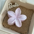 Macro shot of lilac flower hair claw clip with marble texture in a gift box - Pink