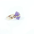 Macro view of gold metal band securing a large purple hexagonal crystal on this unique ring - Purple Crystal