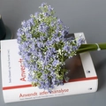Artificial Gypsophila bouquet in purple finish placed on a book for wedding decor - Purple