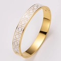 Gold plated stainless steel bangle featuring white enamel geometric patterns on the surface - White Enamel