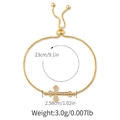 Macro view of gold-plated cross bracelet with white rhinestones and size dimensions - Cross Style