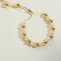 Adjustable 14K gold plated beaded bracelet featuring white pearls and slide clasp - 8mm
